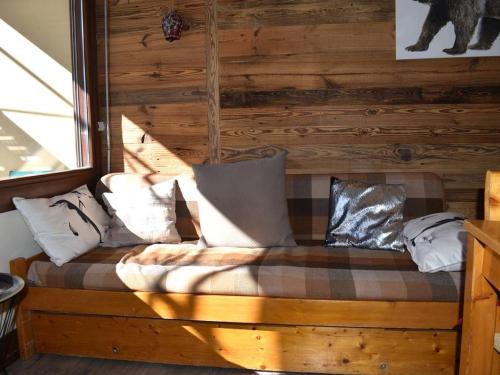 Ce lit se trouve dans une cabane en rondins dotée d'oreillers. dans l'établissement Charmant T2 cabine style chalet, près du centre et télécabines, parfait pour les vacances - FR-1-580-123, à Font-Romeu-Odeillo-Via