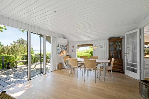 a kitchen and dining room with a table and chairs at Awesome Home In Knebel With 2 Bedrooms And Wifi in Knebel