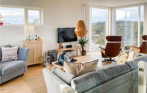 a living room with a couch and a tv at Cozy Home In Søndeled With Kitchen in Søndeled