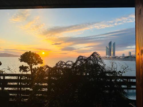 a sunset over a body of water with a city at City Hotel Xiamen-Free Welcome Fruits in Xiamen