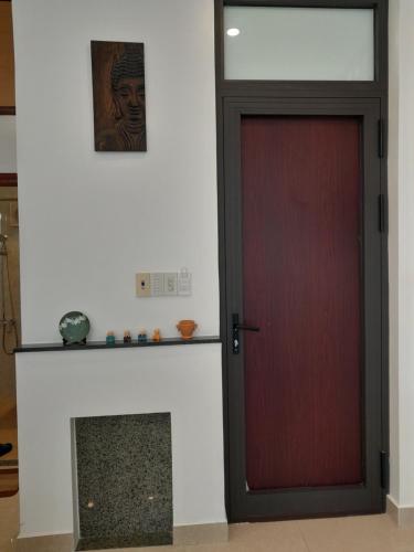 a red door in a room with a fireplace at Tâm Homestay in Hue