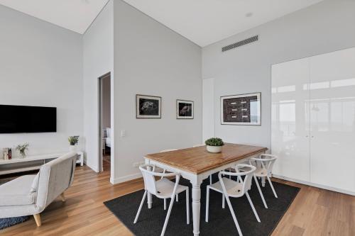 a dining room with a table and chairs at Bokarina Beach Apartments, an Ascend Collection Hotel in Bokarina