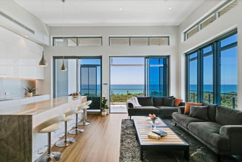 a kitchen and living room with a view of the ocean at Bokarina Beach Apartments, an Ascend Collection Hotel in Bokarina
