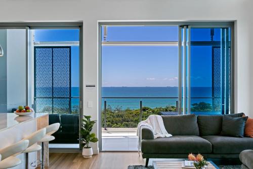 a living room with a view of the ocean at Bokarina Beach Apartments, an Ascend Collection Hotel in Bokarina