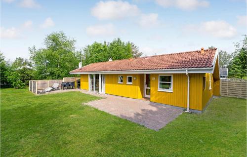 a small yellow house with a large yard at Stunning Home In Fjerritslev With Wifi in Fjerritslev