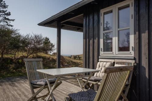 a table and chairs on the porch of a house at Awesome Home In Knebel With 2 Bedrooms And Wifi in Knebel