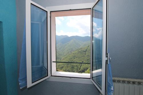 a window with a view of a mountain at L'Incantesimo in Triora