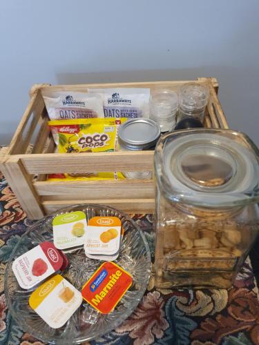 a picnic basket with food and a box of food at The Red Shed in Matamata