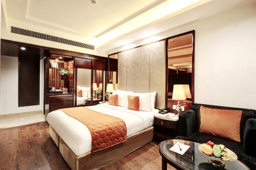 a hotel room with a bed and a couch at Flute Boutique by Hotel 91 in Jaipur
