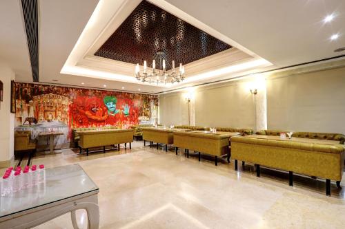 a dining room with chairs and a painting on the wall at Flute Boutique by Hotel 91 in Jaipur