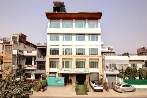 a tall white building with cars parked in front of it at Flute Boutique by Hotel 91 in Jaipur