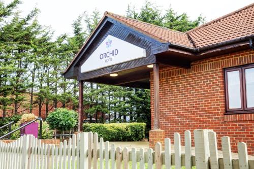 a brick building with a sign for a church at Orchid Epsom; Sure Hotel Collection by Best Western in Epsom
