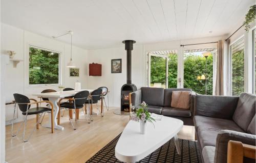 a living room with a couch and a table at 3 Bedroom Amazing Home In Børkop in Børkop