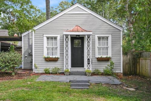 a small white house with a door and windows at Cloverdale Cottage in Montgomery