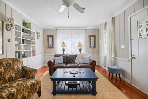 a living room with a couch and a table at Cloverdale Cottage in Montgomery