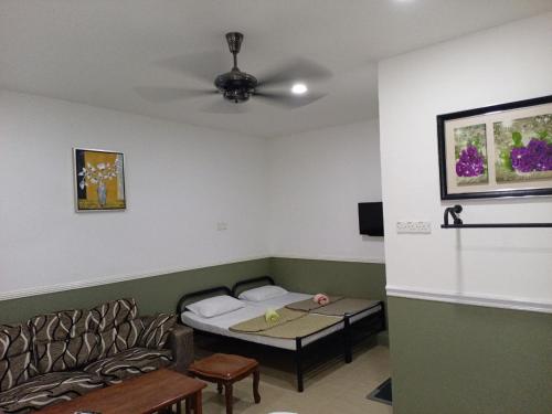 a living room with a couch and a table at Hotel Seri Intan Tampin in Tampin