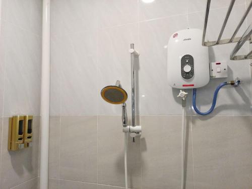 a shower in a bathroom with a camera on the wall at Hotel Seri Intan Tampin in Tampin