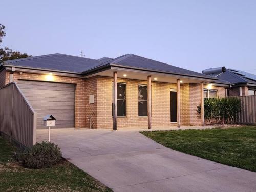 a brick house with a garage and a driveway at 2 bedroom house Central Nagambie sleeps 5 in Nagambie