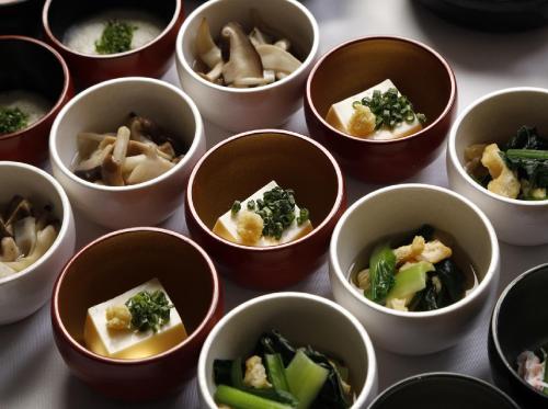 a group of small cups of food with broccoli at Dormy Inn Morioka in Morioka