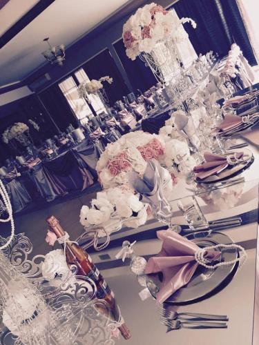 a white table with a bunch of flowers on it at Hotel Fantazia in Haskovo