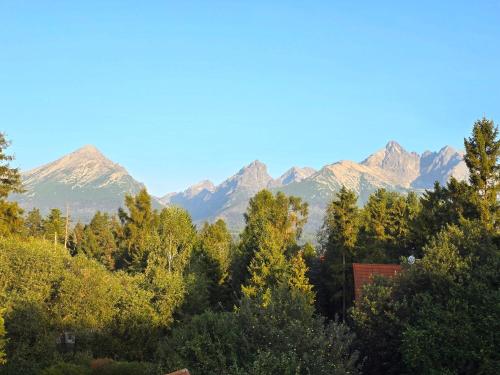 a view of a mountain range with trees at Wellness Toliar Tatry in Stará Lesná