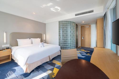 Ένα ή περισσότερα κρεβάτια σε δωμάτιο στο Holiday Inn Express - Qingdao West Coast by IHG
