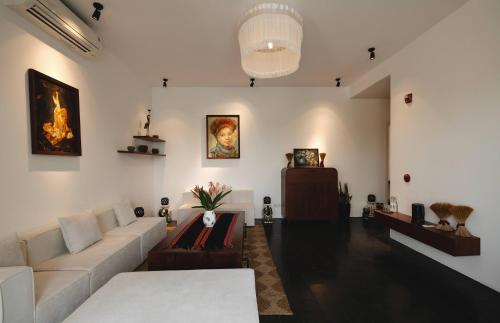 a living room with a couch and a table at aNhill Boutique in Hue