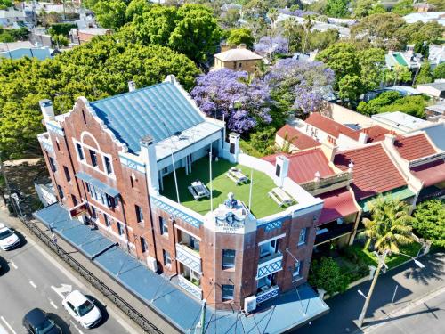 an overhead view of a brick building with a green roof at Pad Hostel in Sydney