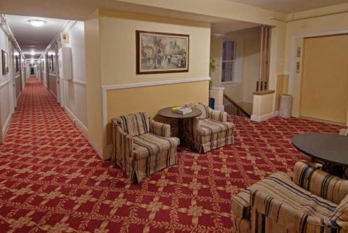 a hotel lobby with chairs and a table and a table at Aida Plaza Hotel in San Francisco