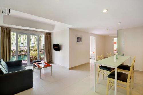 a living room with a couch and a table at HARRIS Hotel & Residences Riverview Kuta, Bali in Kuta