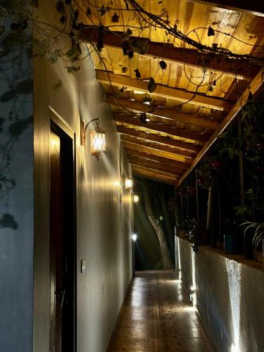 a hallway of a building with a wooden ceiling at Oakakhi Stays, Deluxe room in Rānīkhet