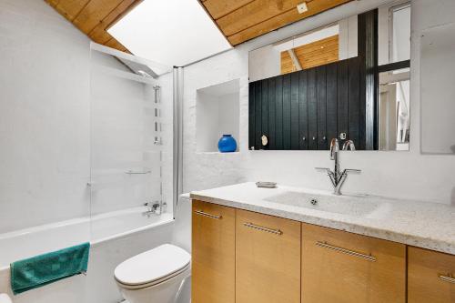 a bathroom with a sink and a toilet and a shower at Cozy House On Helgenæs in Knebel