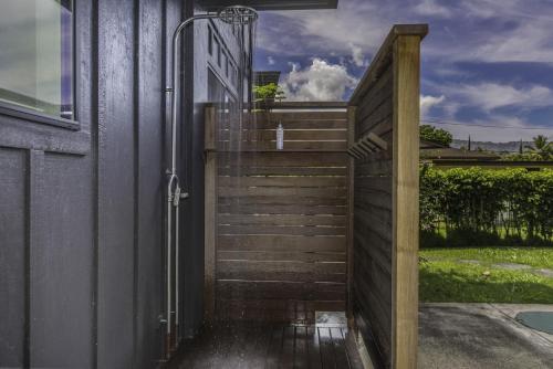an open door to a house with a fence at Hale Hanalei home in Hanalei