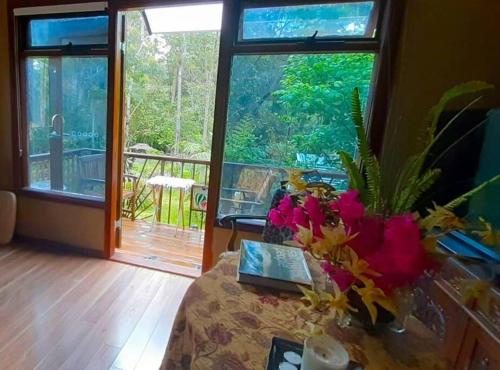 a living room with a table with flowers on it at Blue Mountains Ferncreek studio retreat pet friendly in Hazelbrook