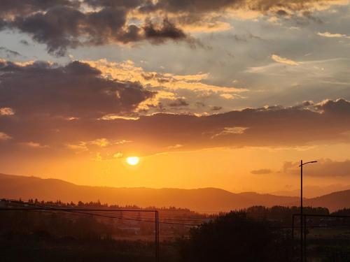a sunset with the sun setting over the mountains at Cozy Apartment 201A • BMIX • in Bakuriani