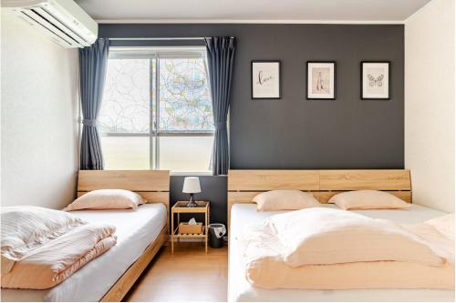 Postel nebo postele na pokoji v ubytování guesthouse みつば