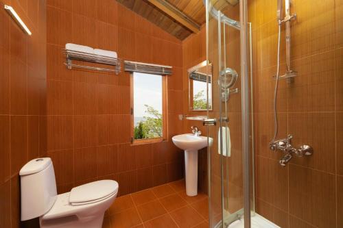 a bathroom with a shower and a toilet and a sink at Fortune Resort & Wellness Spa Bhaktapur, Nepal - Member ITC Hotels' Group in Bhaktapur