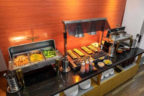a buffet line with food in a hotel room at Hotel Azumaya Linh Lang in Hanoi