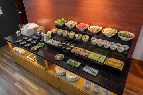 a buffet with many different types of food on display at Hotel Azumaya Linh Lang in Hanoi