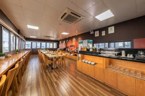 a restaurant with wooden tables and counters and a kitchen at Hotel Azumaya Linh Lang in Hanoi