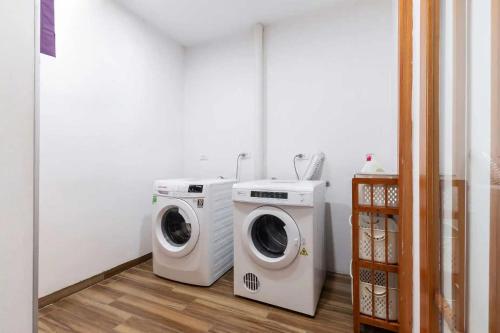 two washing machines and a washer and dryer in a room at Hotel Azumaya Linh Lang in Hanoi