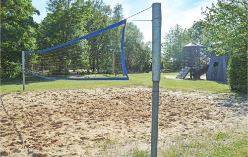 a volley ball net in a park with a playground at Søhøjlandet in Gjern