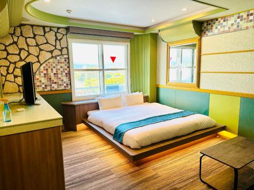 Postel nebo postele na pokoji v ubytování 富士Outlet温泉Hotel