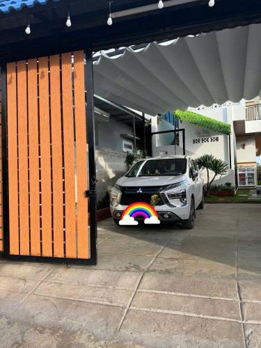 a car with a rainbow painted on the side of it at Sea-Breeze Homestay in Phan Thiet