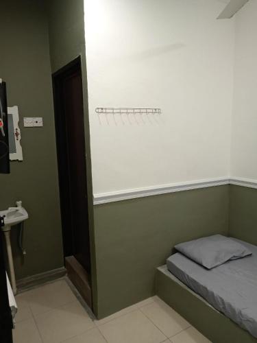 a room with a bed and a wall with at Hotel Seri Intan Tampin in Tampin