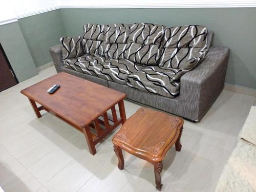 a living room with a couch and a table at Hotel Seri Intan Tampin in Tampin
