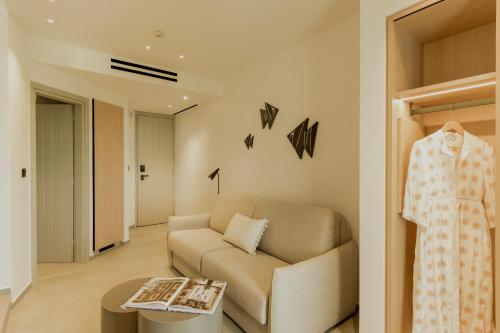 a living room with a couch and a table at Opal Paros in Naousa