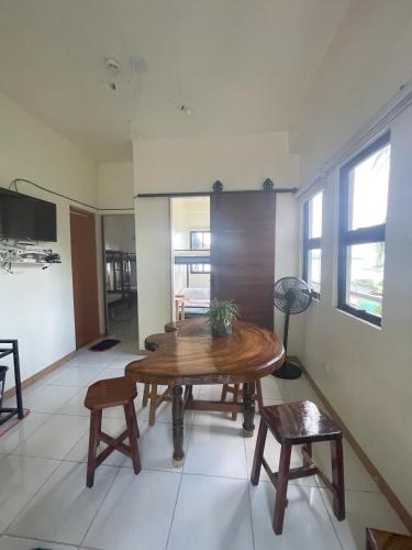 a living room with a wooden table and chairs at Pamasyar Transient Inn in Romblon