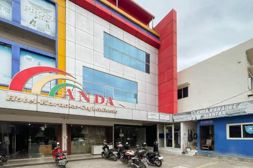 a group of motorcycles parked in front of a building at RedDoorz at Hotel Anda Pematang Siantar in Pematangsiantar
