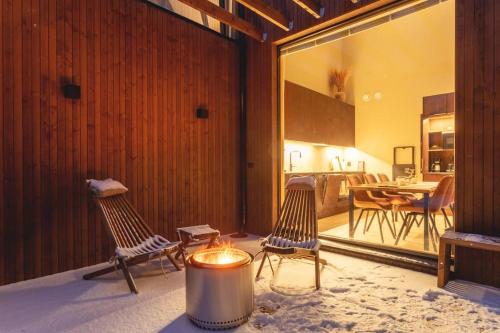 a living room with two chairs and a table at Stay North - Joiku - Voice of Lapland in Äkäslompolo